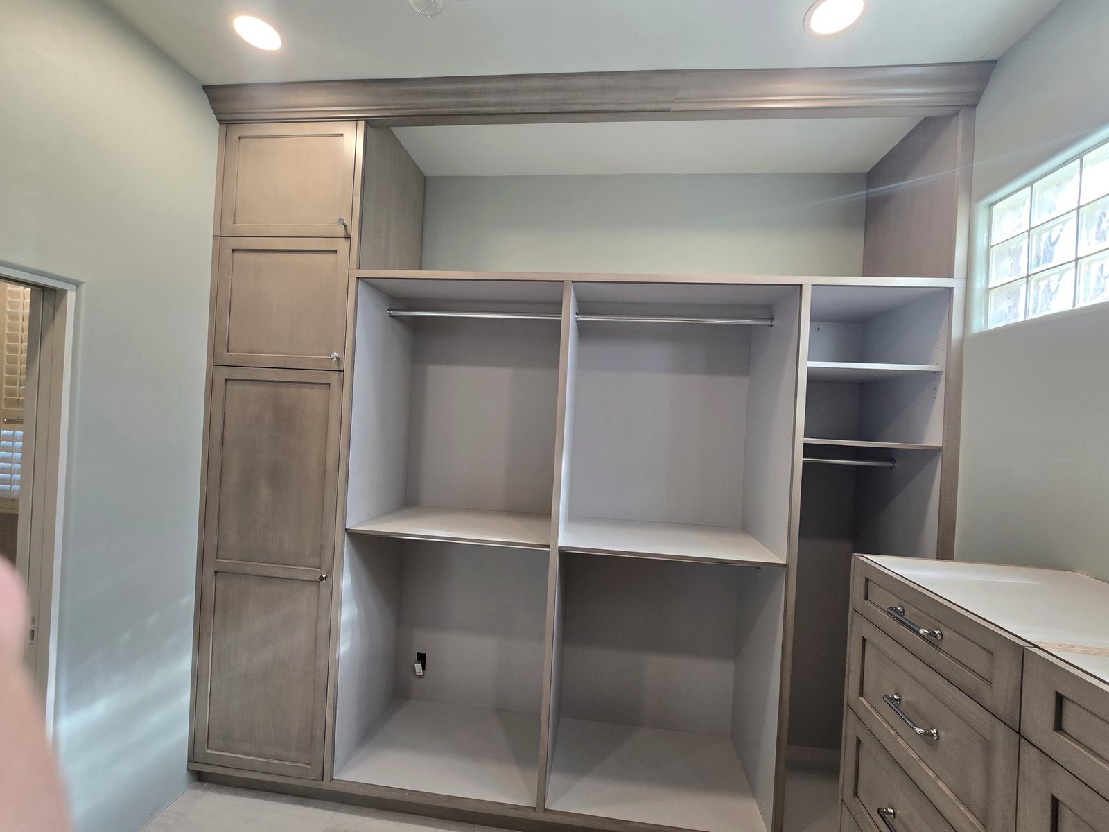 Custom closet cabinet installation with tall storage and drawer base