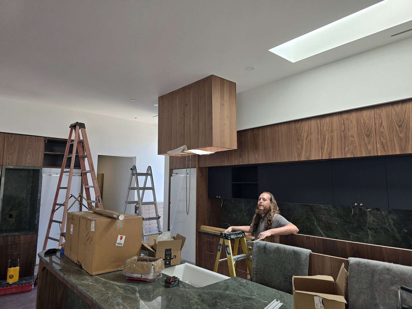Install Crew team member working on site in a custom kitchen during cabinet installation