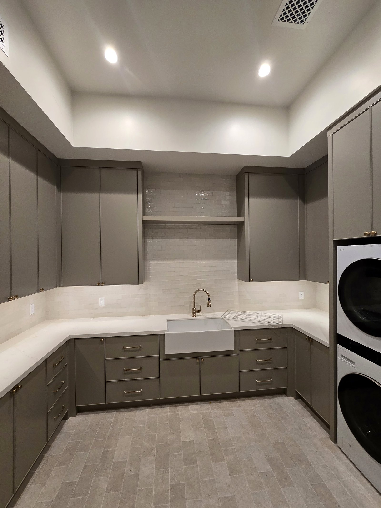 Laundry room cabinet installation with upper cabinets and long lower storage run