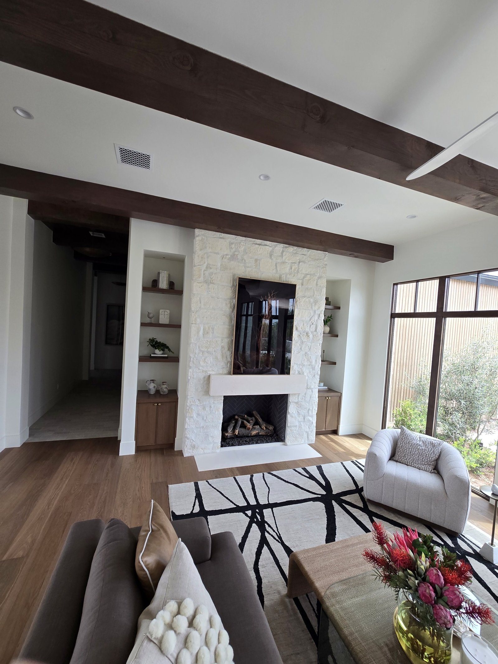 Living room fireplace built-ins with stone fireplace and shelving