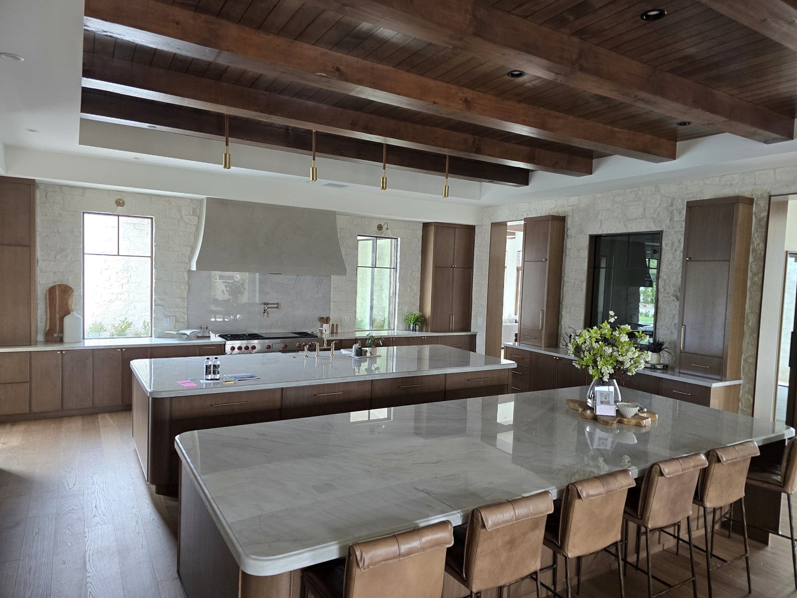 Large custom kitchen cabinet installation in a premium Scottsdale home with dark wood cabinetry and a large island