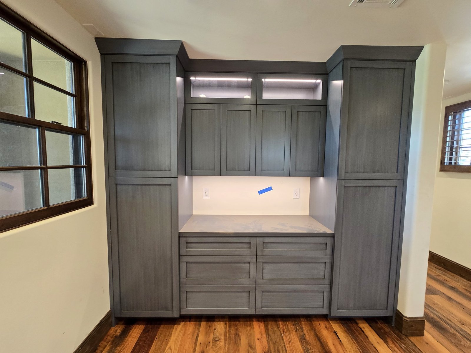 Wardrobe and built-in cabinet installation with accent lighting and drawers